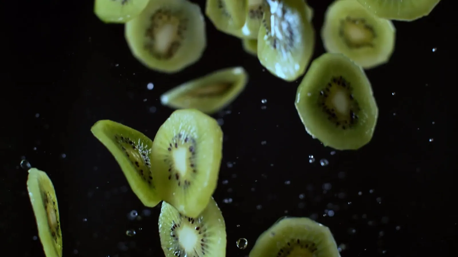 Kiwi slices suspended mid-chop, from the TM7 film